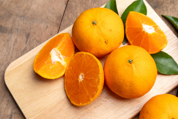 Whole fresh mandarin oranges Sliced ??and freshly separated orange juice on a wooden table. Relieves dehydration, reduces phlegm and stimulates the lungs, helps in reducing constipation and helps reduce fever and aids digestion. High in vitamin C.|orange-