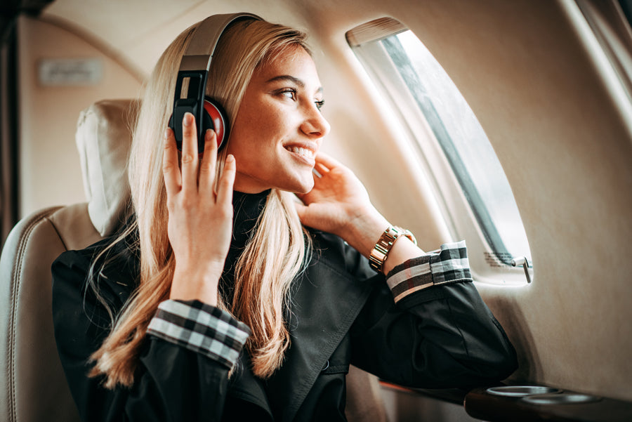 Young businesswoman sitting in a private airplane