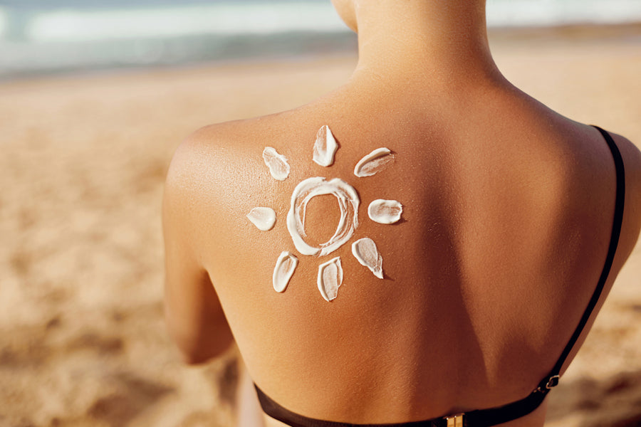 Skin care. Sun protection. Woman apply sun cream. Woman With Suntan Lotion On Beach In Form Of The Sun. Portrait Of Female With  Drawn Sun On A Shoulder. Suncream. Girl Holding Moisturizing Sunblock.|Young businesswoman sitting in a private airplane